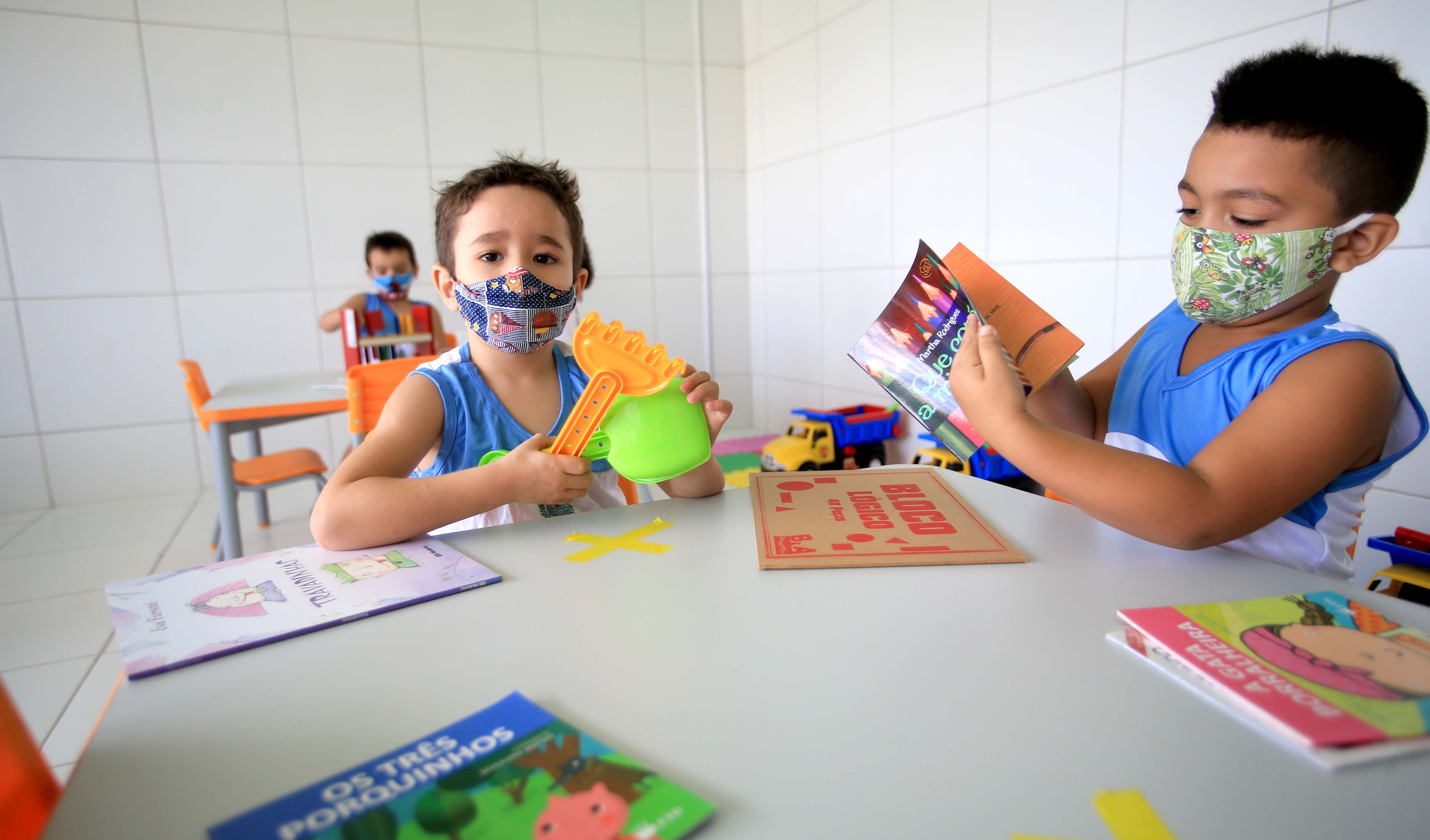 dois meninos em uma mesinha na sala de aula do centro de educação infantil